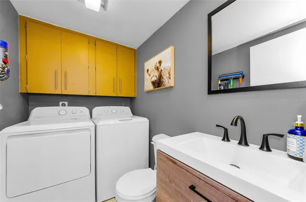 a bathroom with a sink and a washer dryer