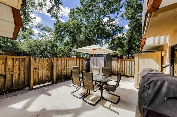 a view of a chairs and tables in the back yard of the house