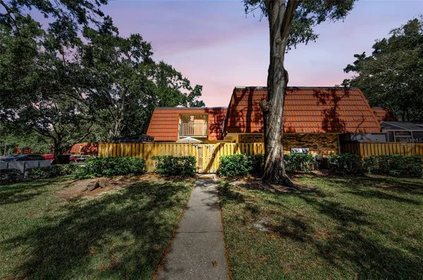 a aerial view of a house with a yard and lake view