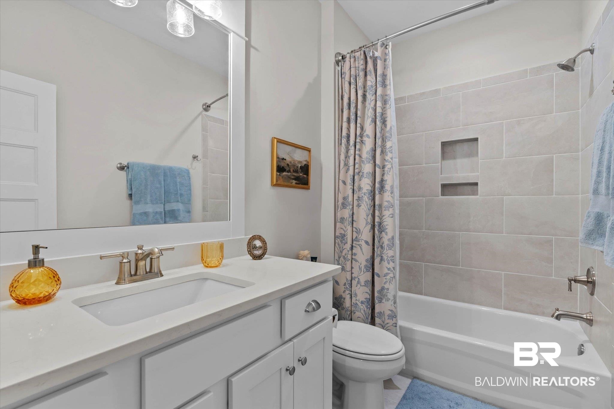 23523 Travis Stock Street Foley, AL 36535 - Photo 26 of 45 Bathroom featuring a white vanity with an integrated sink, brushed nickel faucet, and a large wall mirror