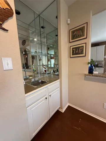 a room with a sink and a mirror