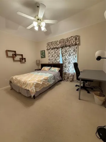 a bedroom with a bed a desk and chair