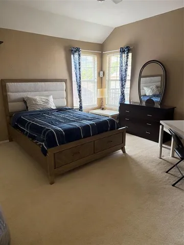 a bed room with a bed and a large window