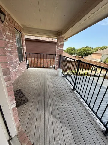 a view of balcony with wooden floor