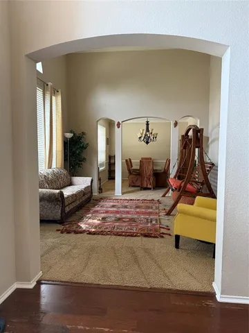 a living room with furniture and a gym