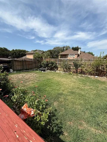 a view of a garden with lawn chairs