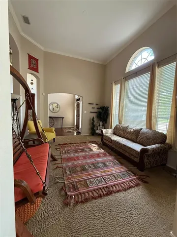 a living room with furniture a rug and a large window