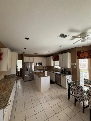 a kitchen with sink cabinets and window