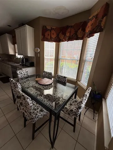 a kitchen with a table chairs and a stove