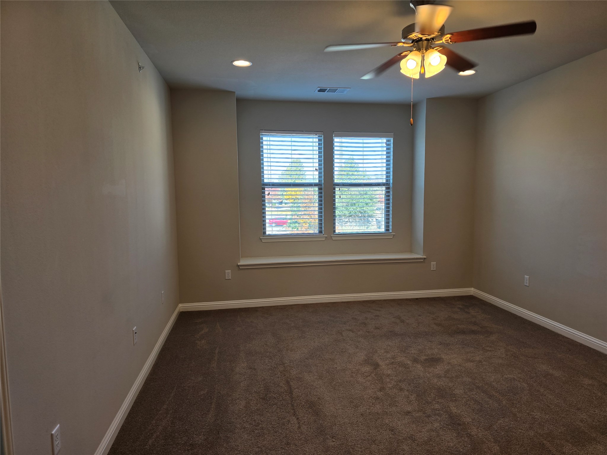 13800 Lyndhurst Street, Unit 233 Austin, TX 78717 - Photo 14 of 38 en empty room with windows and ceiling fan