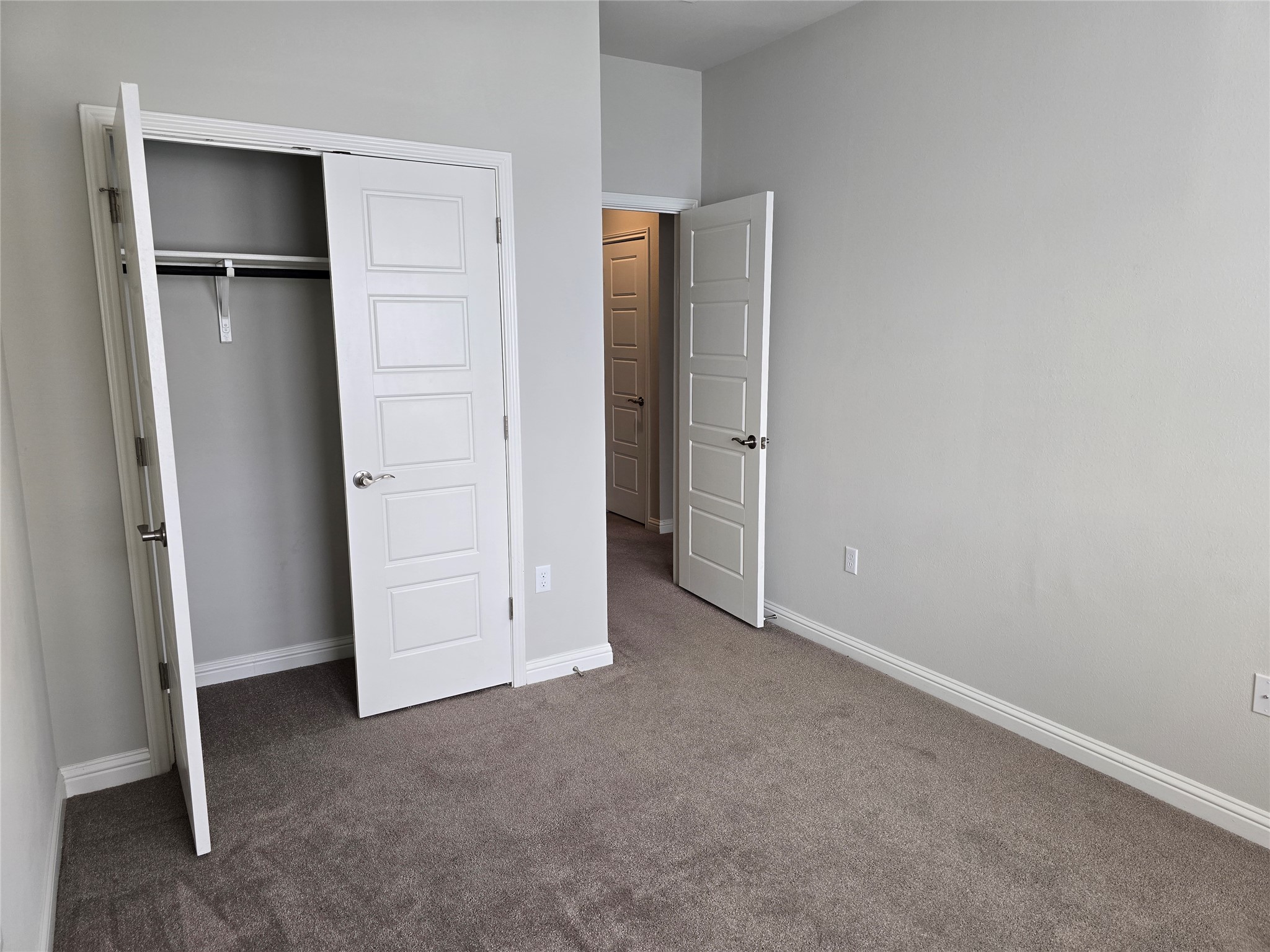 13800 Lyndhurst Street, Unit 233 Austin, TX 78717 - Photo 32 of 38 an empty room with closet and wooden door