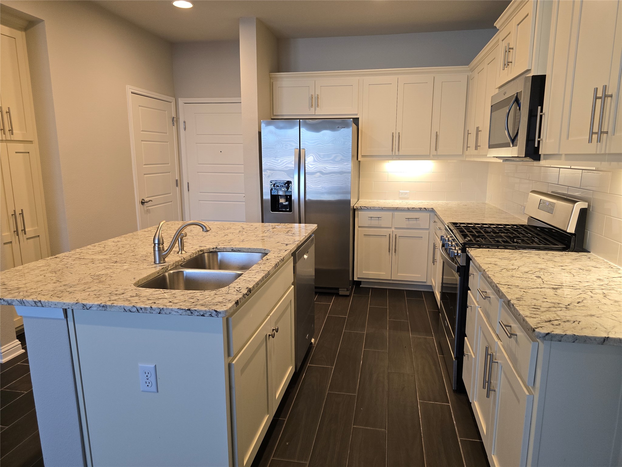 13800 Lyndhurst Street, Unit 233 Austin, TX 78717 - Photo 9 of 38 a kitchen with a sink stove and cabinets