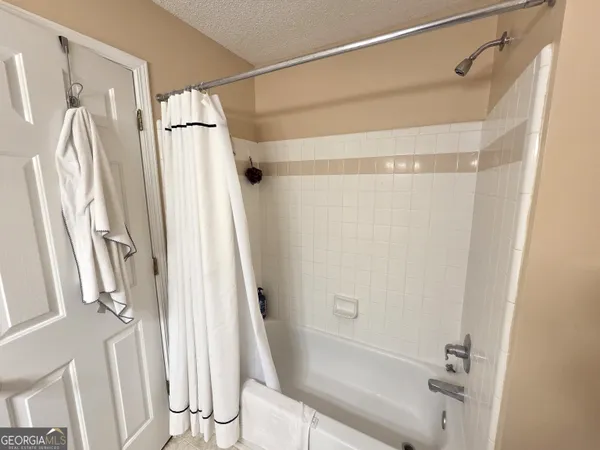 a bathroom with a shower and a glass door