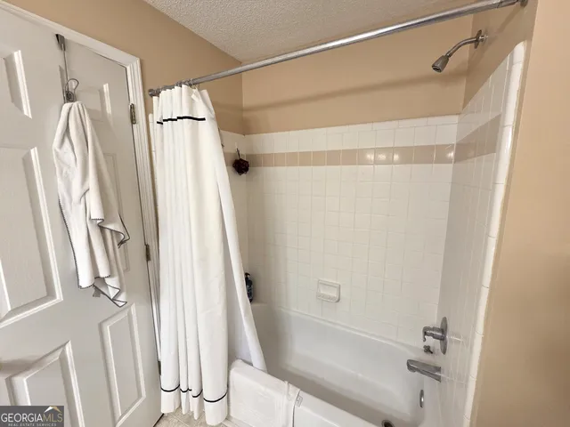 a bathroom with a shower and a glass door