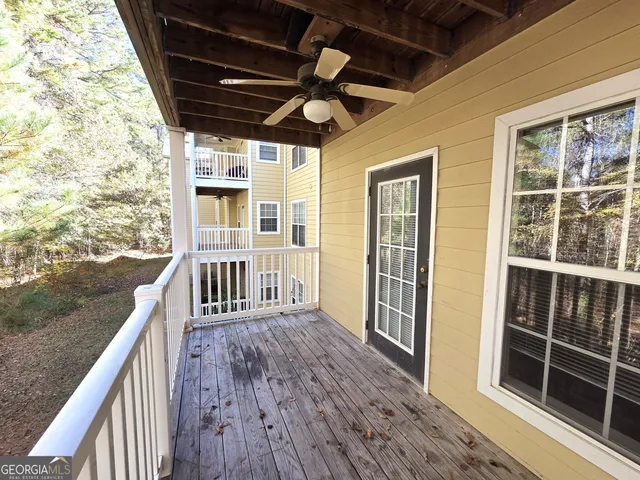a view of balcony with wooden floor and fence