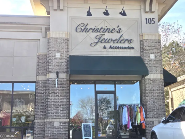 a front view of a building with retail shop and a front door