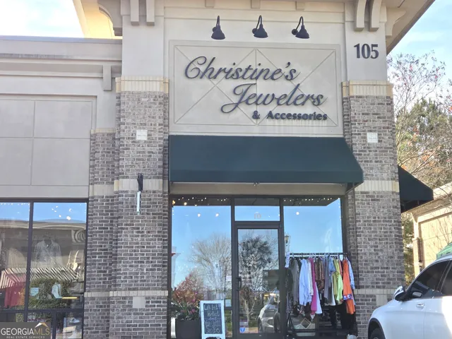 a front view of a building with retail shop and a front door