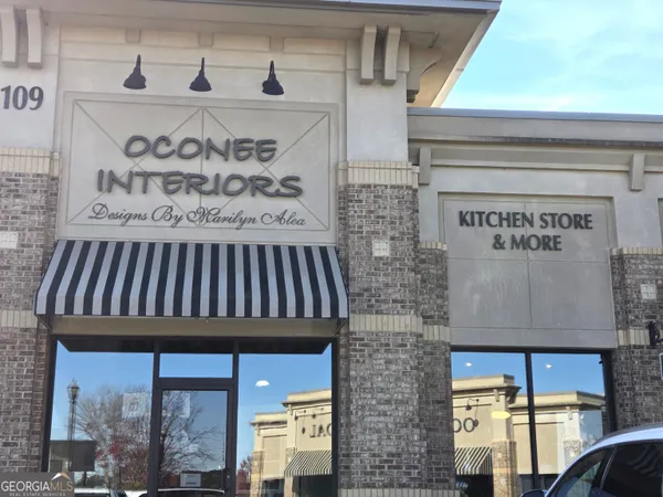 a view of a lobby with a chair and a fireplace