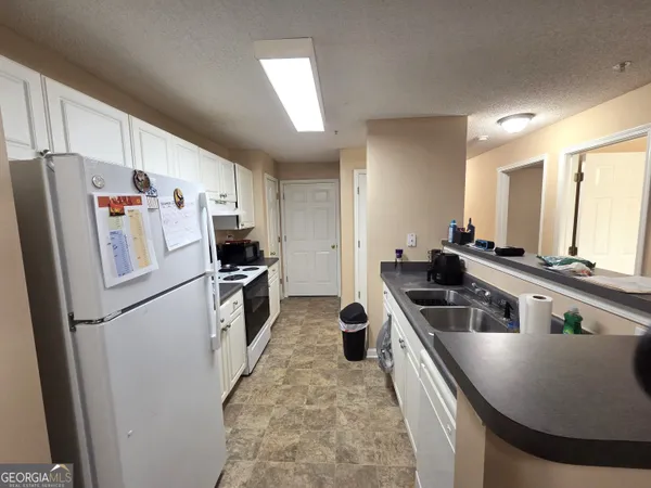 a kitchen with a refrigerator a sink and a refrigerator