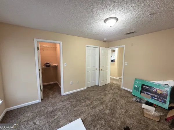 an empty room with closet and a bathroom