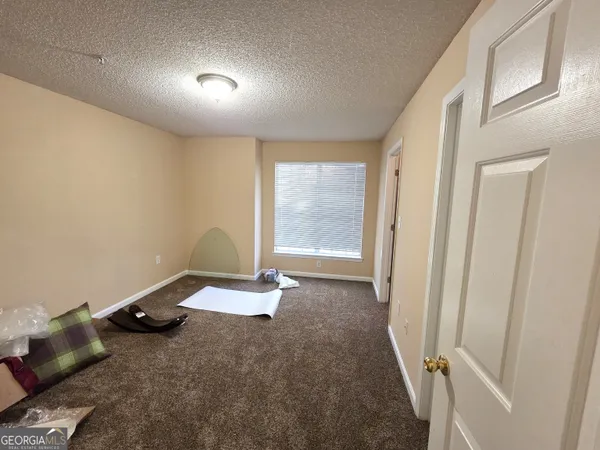 a view of a room with wooden floor and window