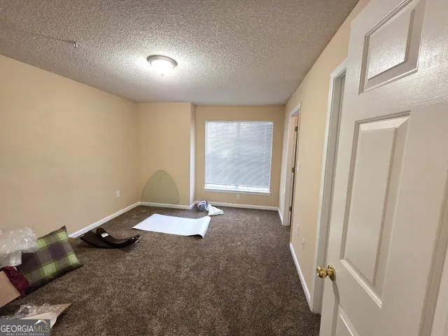 a view of a room with wooden floor and window