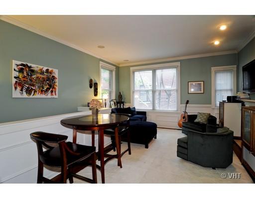 4046 North Clark Street, Unit L Chicago, IL 60613 - Photo 2 of 10 a living room with furniture a flat screen tv and a window