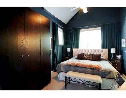 4046 North Clark Street, Unit L Chicago, IL 60613 - Photo 7 of 10 a bedroom with a bed and a night stand