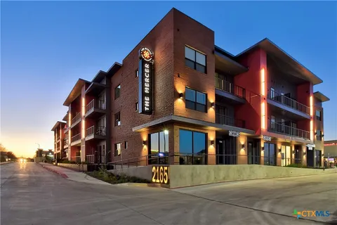 a view of a building with a street