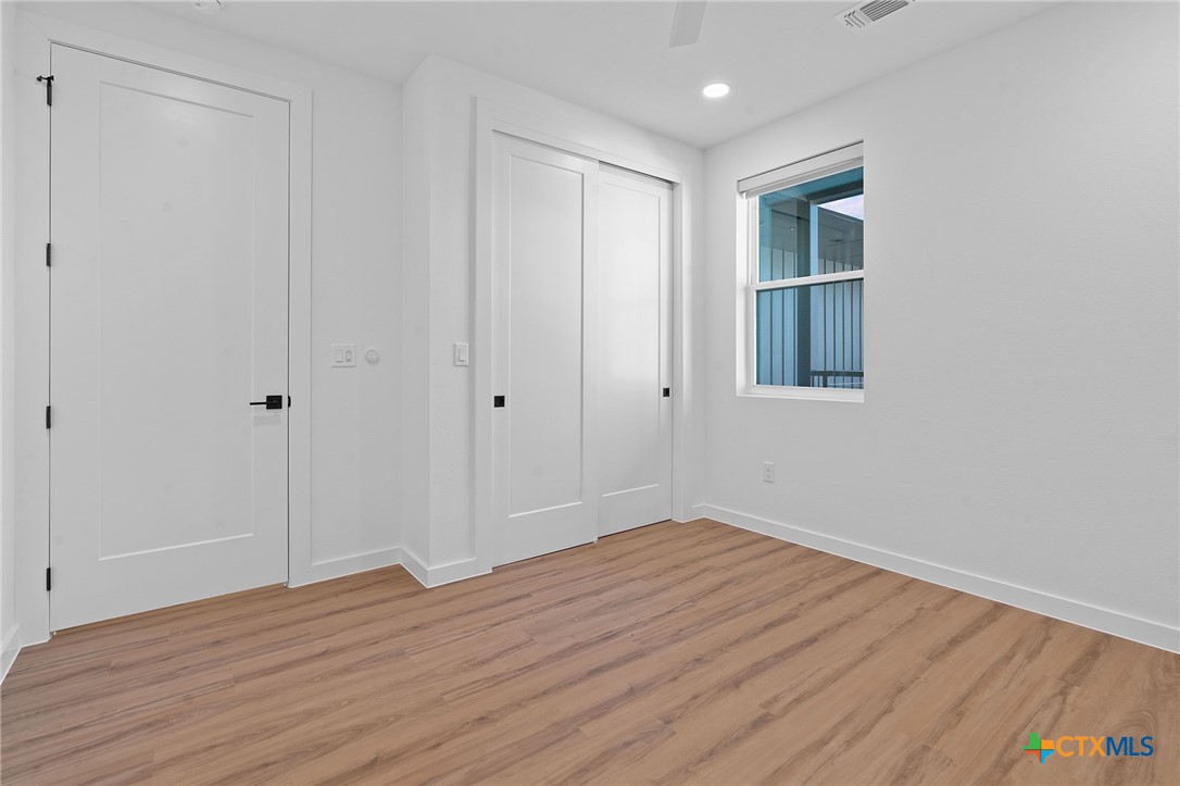 2165 Gabriels Place, Unit 1203 New Braunfels, TX 78130 - Photo 16 of 38 a view of a room with wooden floor and entryway