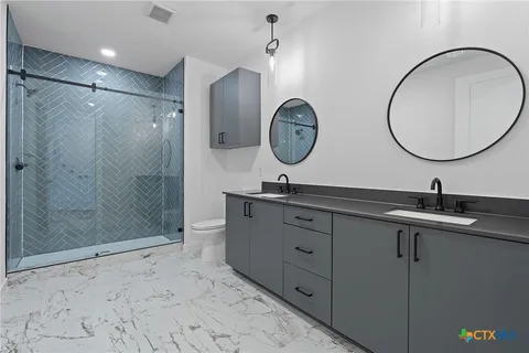 a bathroom with a sink a shower and a mirror
