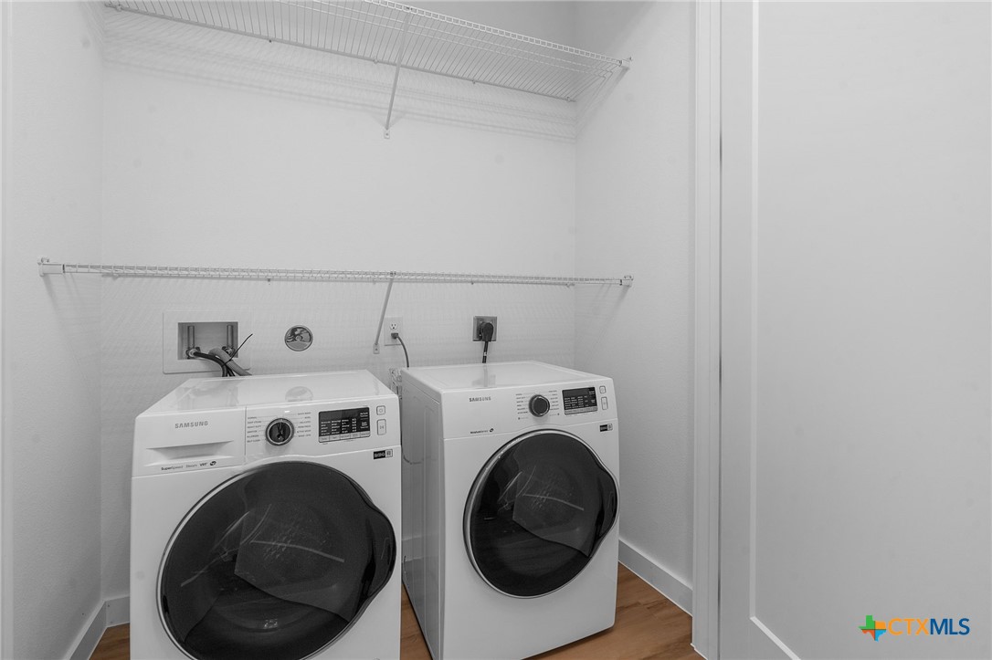 2165 Gabriels Place, Unit 1203 New Braunfels, TX 78130 - Photo 19 of 38 a utility room with dryer and washer