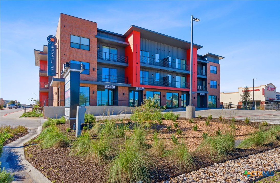 2165 Gabriels Place, Unit 1203 New Braunfels, TX 78130 - Photo 31 of 38 a front view of a building with garden