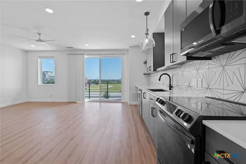 a view of kitchen with cabinets and wooden floor