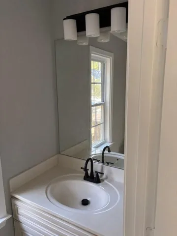 a bathroom with a sink and mirror