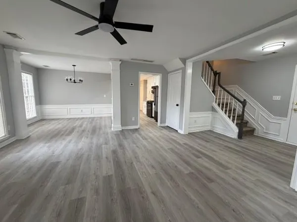 a view of an entryway with wooden floor