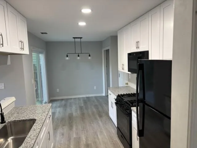a kitchen with a refrigerator and a stove top oven