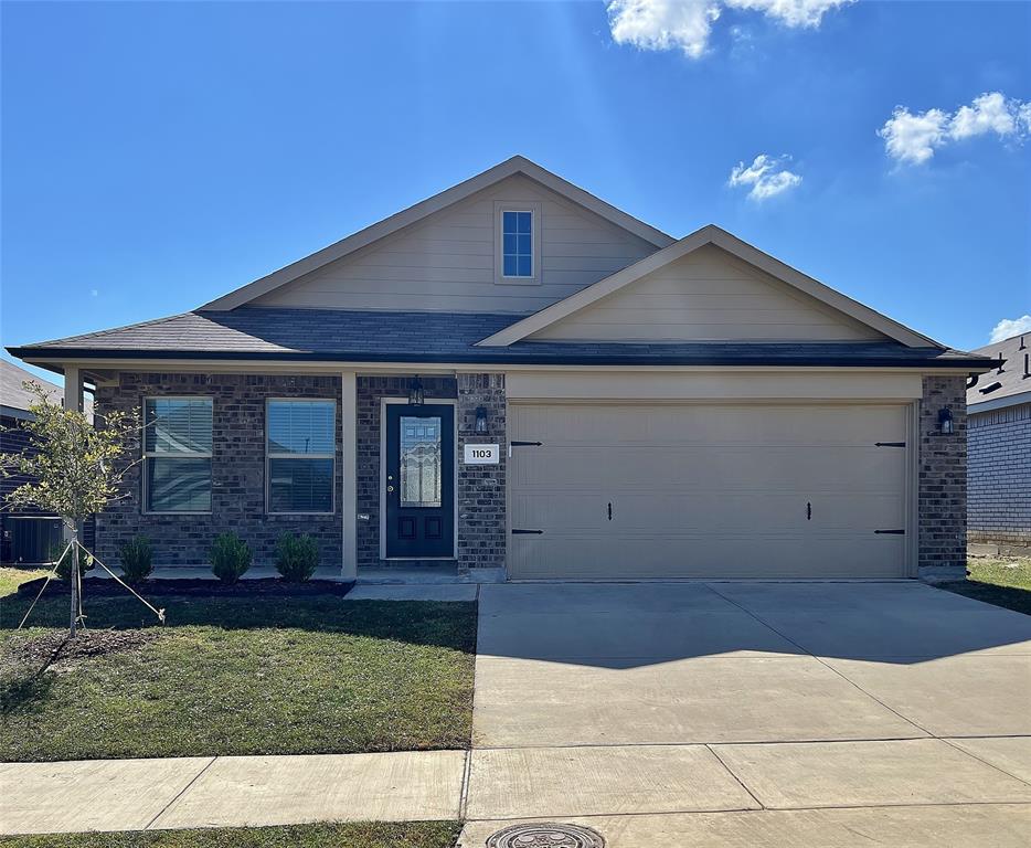 1103 Wildflower Street Ennis, TX 75119 - Photo 1 of 15 a front view of a house with a yard