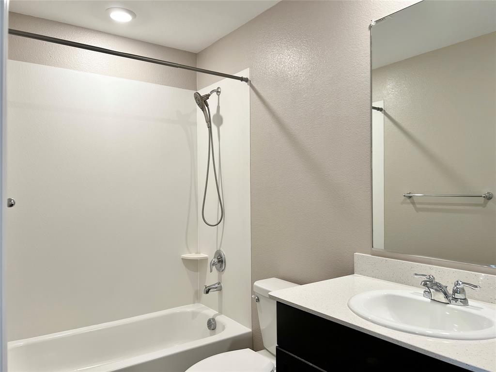 1103 Wildflower Street Ennis, TX 75119 - Photo 12 of 15 a bathroom with a sink and a mirror