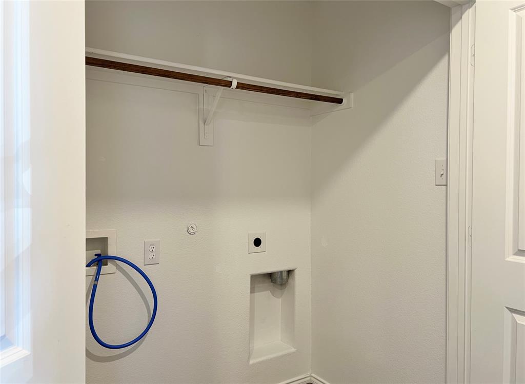 1103 Wildflower Street Ennis, TX 75119 - Photo 13 of 15 a bathroom with a shower and a mirror