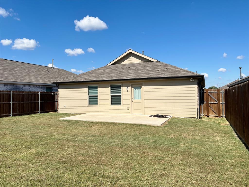 1103 Wildflower Street Ennis, TX 75119 - Photo 14 of 15 a view of a house with backyard and garden