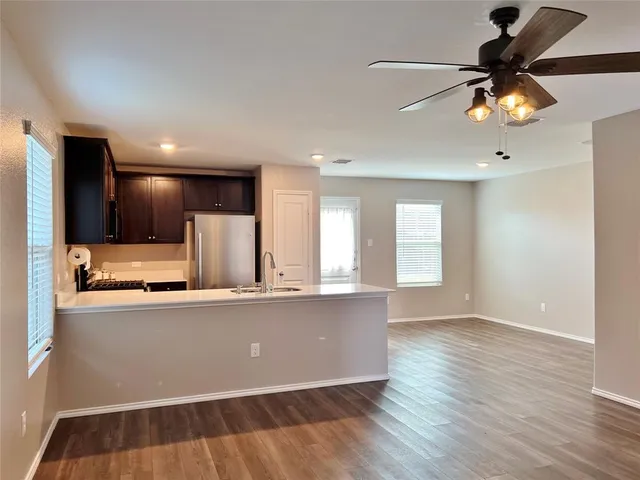 a view of a kitchen with a sink and a window