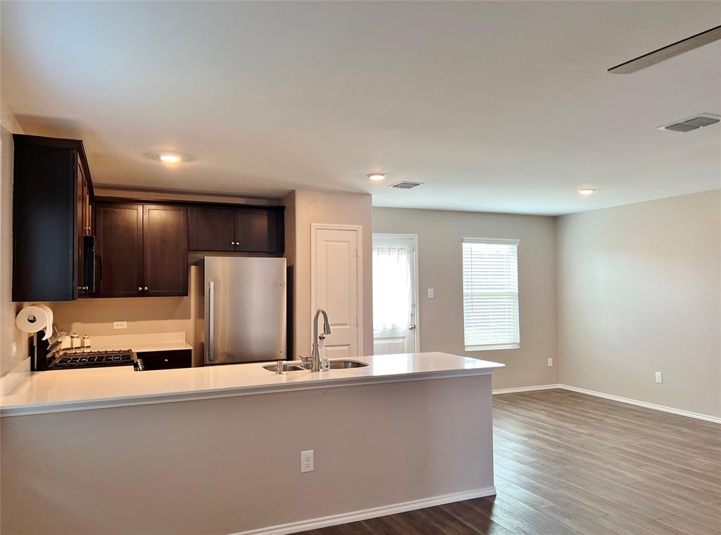 1103 Wildflower Street Ennis, TX 75119 - Photo 4 of 15 a view of kitchen with stainless steel appliances granite countertop a refrigerator and a sink