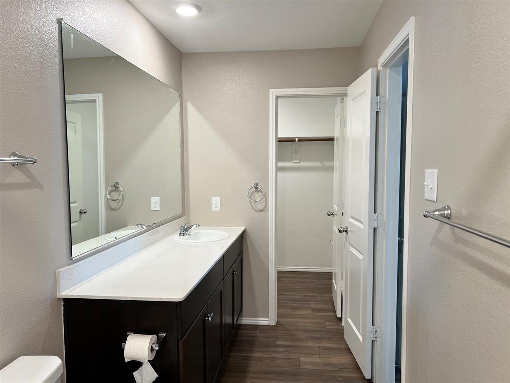 1103 Wildflower Street Ennis, TX 75119 - Photo 9 of 15 a bathroom with a sink a toilet and shower