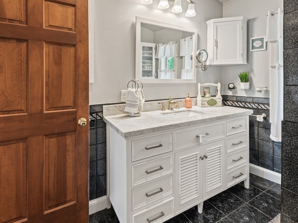 108 Pleasant Valley Road Amesbury, MA 01913 - Photo 23 of 42 a bathroom with a sink double vanity and a mirror