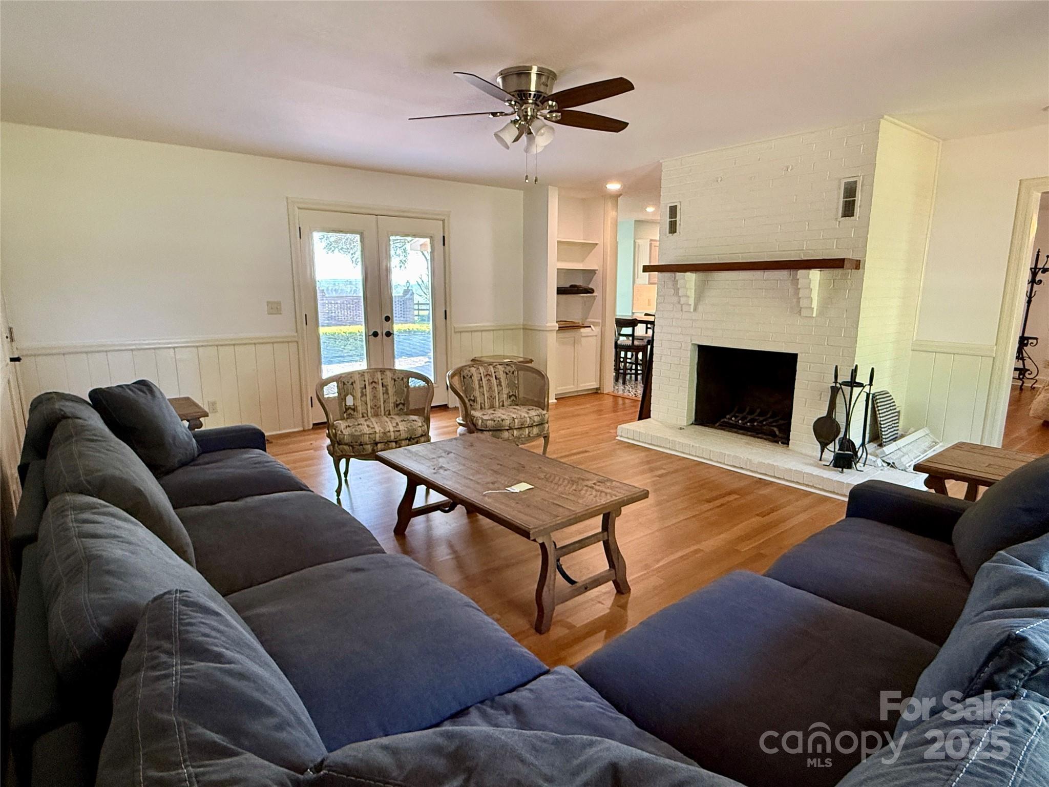 820 Phillips Road Columbus, NC 28722 - Photo 21 of 32 a living room with furniture a fireplace and a chandelier