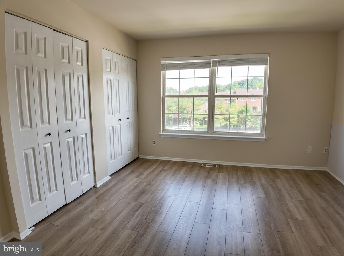 3614 Fawn Spring Court Baltimore, MD 21234 - Photo 3 of 22 an empty room with wooden floor and windows