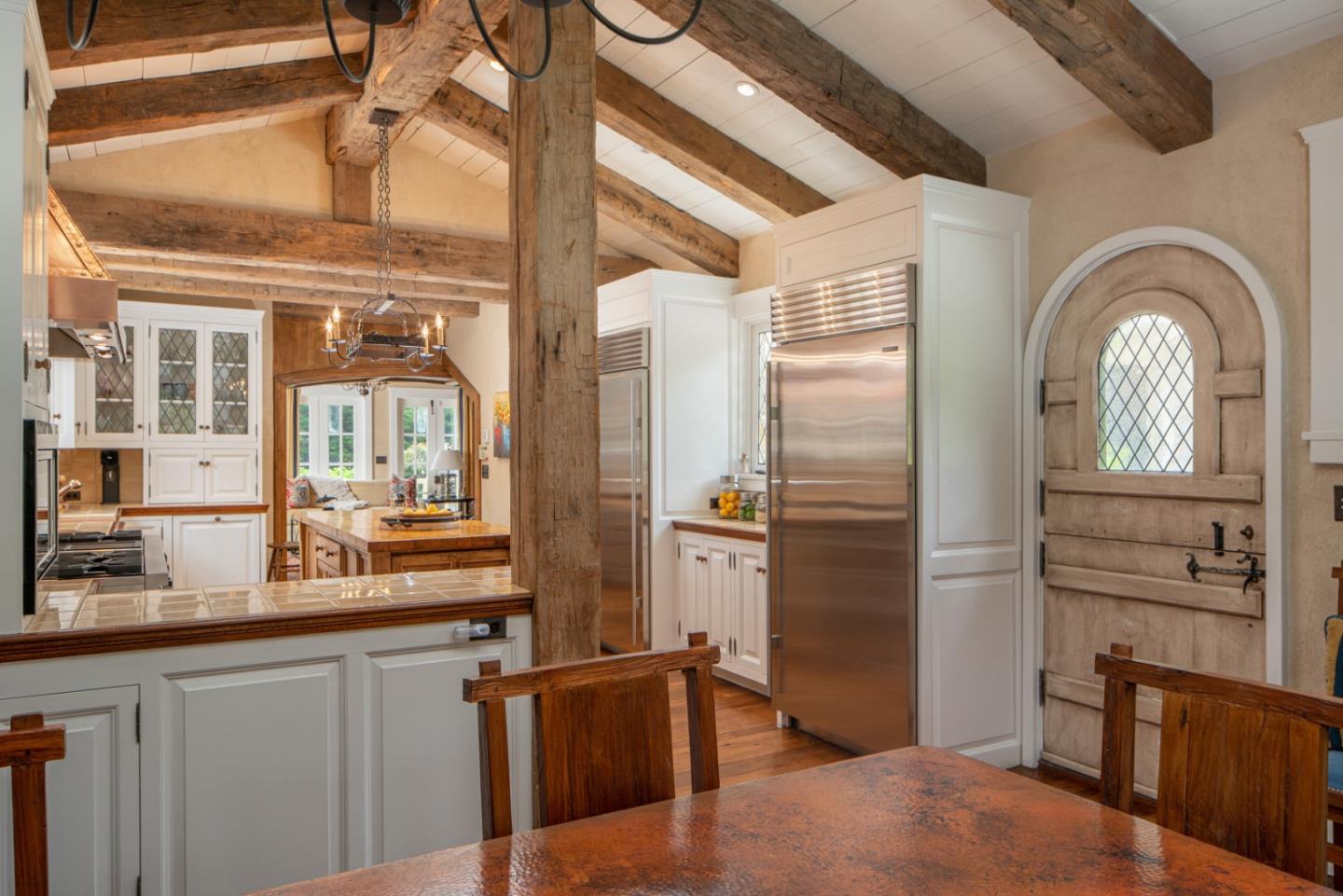 1456 Riata Road Pebble Beach, CA 93953 - Photo 11 of 32 a kitchen with stainless steel appliances granite countertop a refrigerator and wooden cabinets