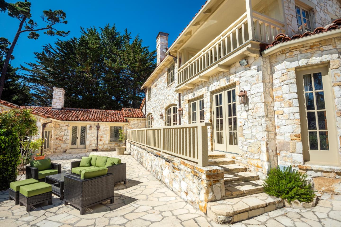 1456 Riata Road Pebble Beach, CA 93953 - Photo 22 of 32 a view of a building with a bench in patio