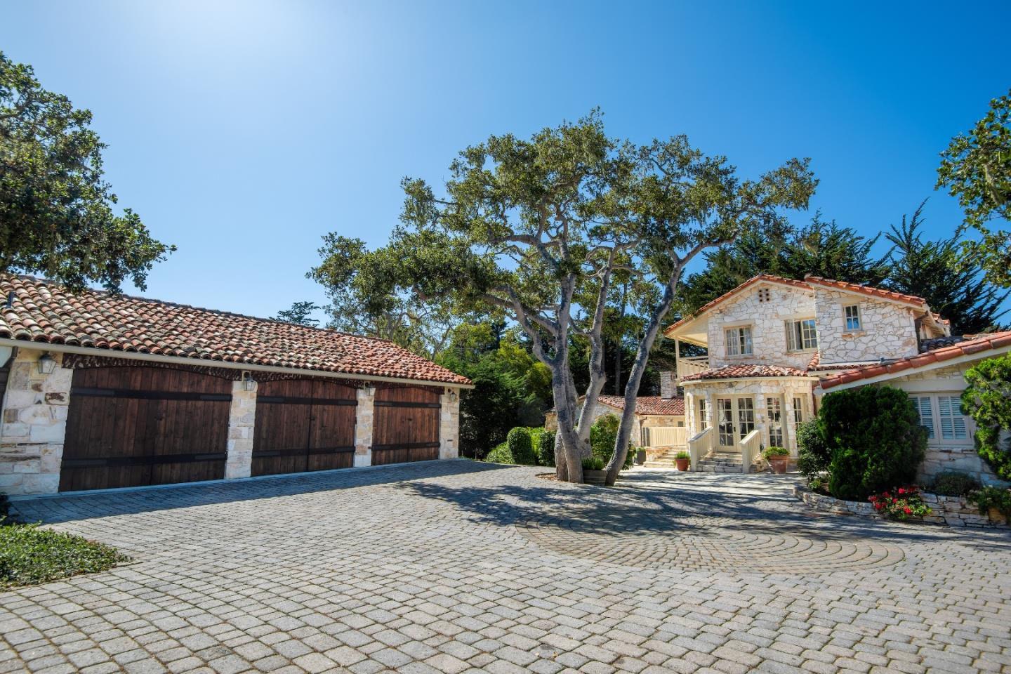 1456 Riata Road Pebble Beach, CA 93953 - Photo 29 of 32 a view of a house with a yard and large tree